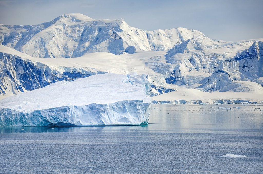iceberg with ocean water in forefront