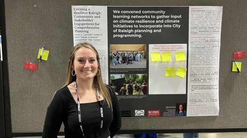 Person standing in front of a research poster