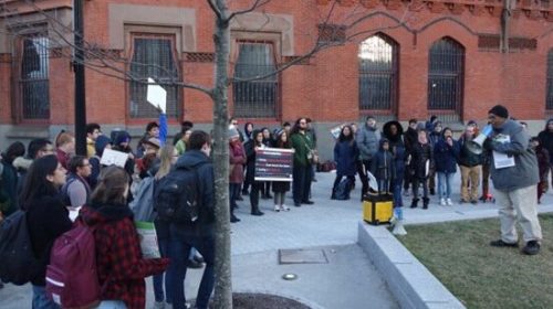 A group gathered outside a brick building