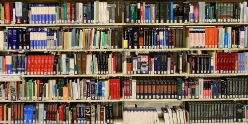 Library bookshelf with five shelves, filled with books