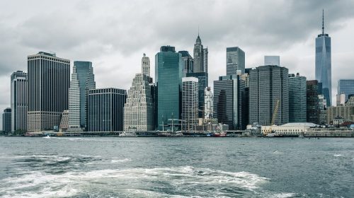 Tall city buildings with water in the foreground